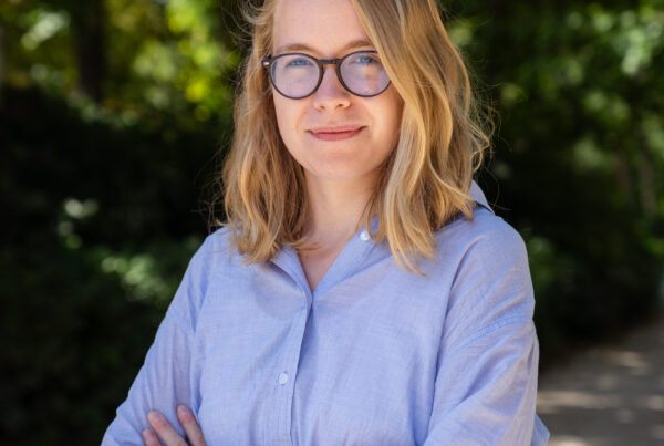 Scholar alumna, Marie Martine photographed standing outside.