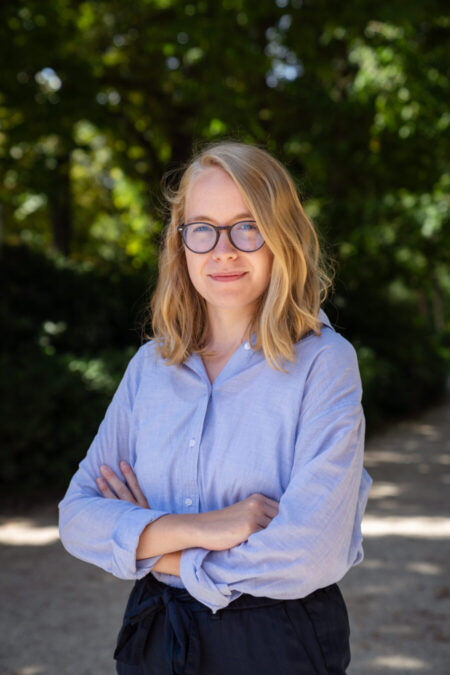 Scholar alumna, Marie Martine photographed standing outside.