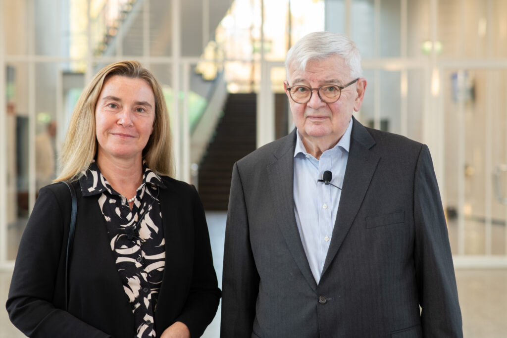 Photo of lecture speakers, Federica Mogherini and Joschka Fischer standing side by side in the Henry Ford Building lobby of Freie Universitaet. Photo copyright: Gareth Harmer.